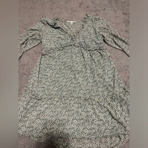 Short green dress with white flowers.